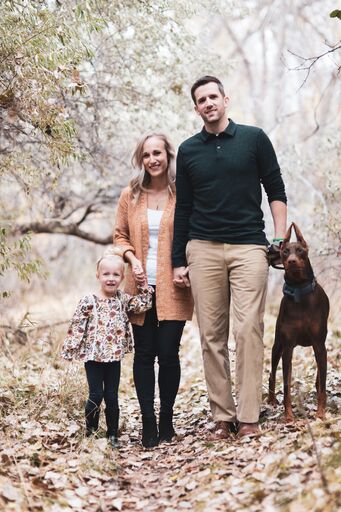photo of Leah, her fiance, daughter and dog.